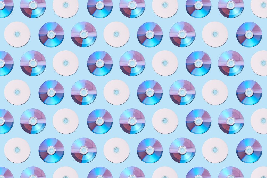 Colorful CDs arranged in a geometric pattern on a light blue background.