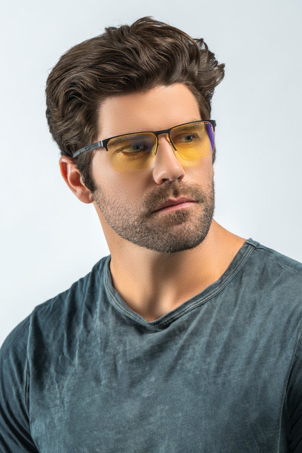 Person wearing black GUNNAR Echo Onyx half-rimless gaming glasses with yellow-amber lenses