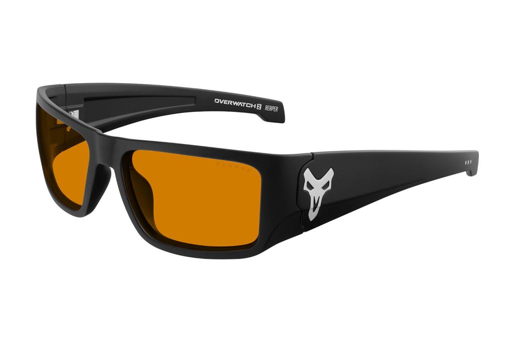 Official GUNNAR product photograph of matte-black Overwatch Reaper gaming glasses with orange-tinted lenses and silver Reaper skull emblem on temple